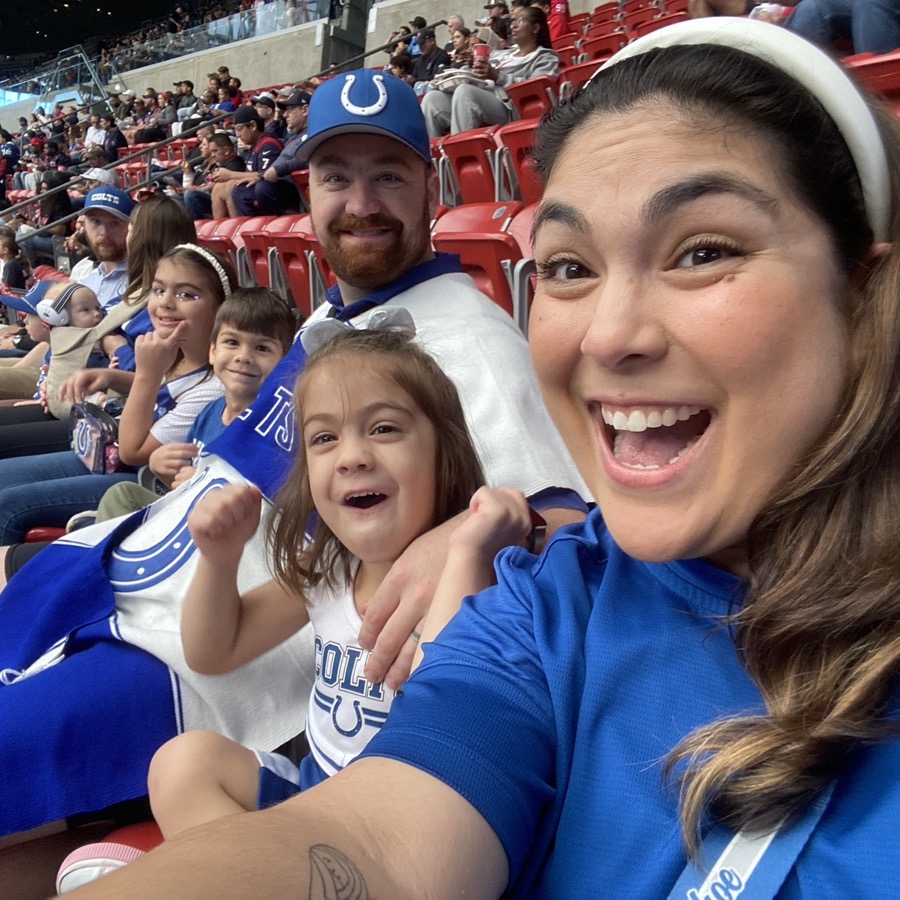 The family cheering in Colts blue at an Indianapolis Colts game